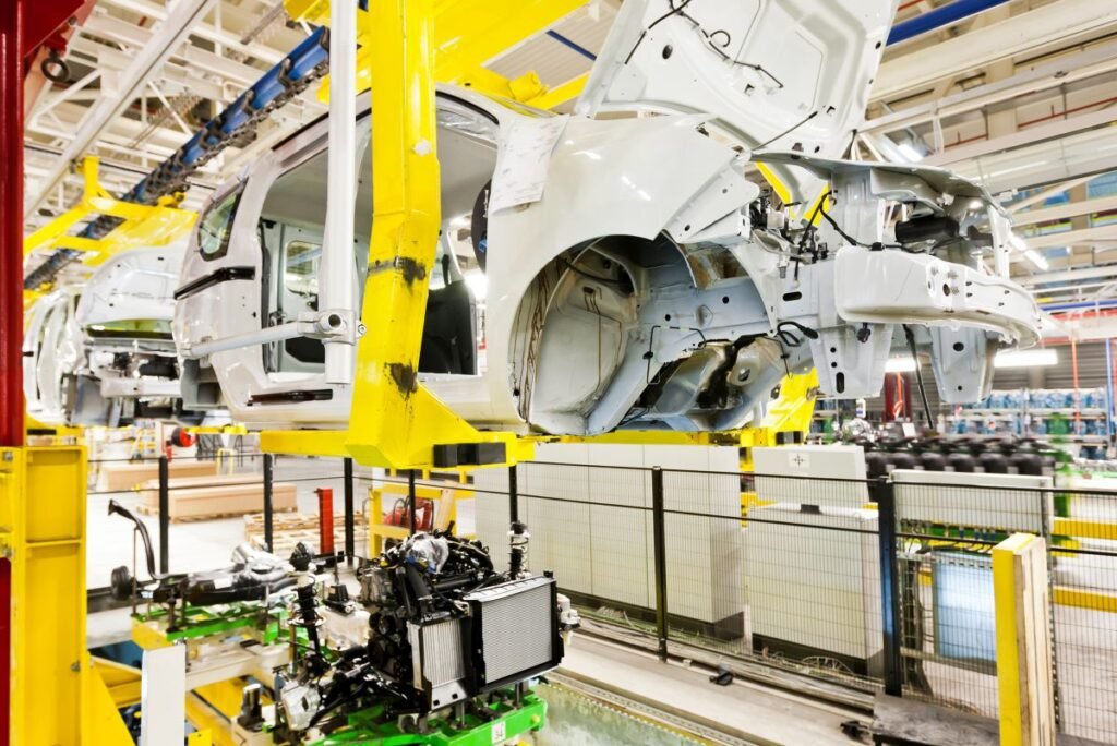 car on assembly line - carbon reporting in auto industry